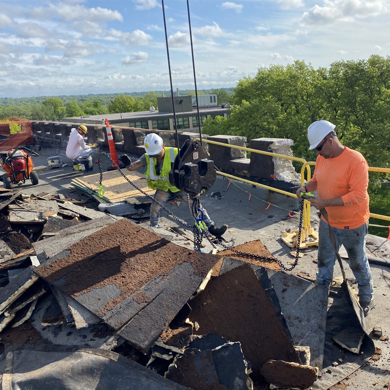 Compass team working on replacing a roof